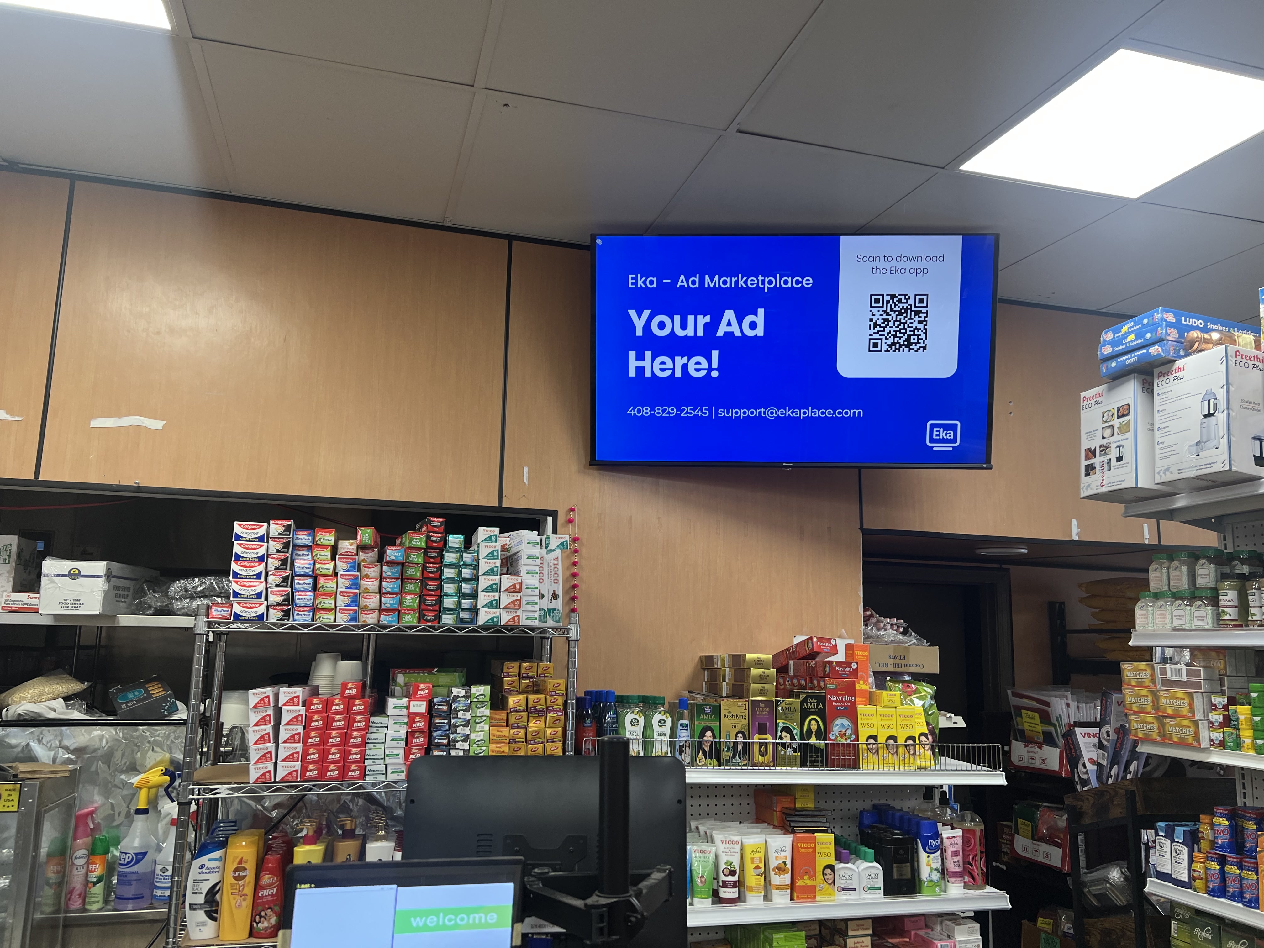 Eka digital screen running inside Coconut Hill Indian grocery store in Pleasanton, CA
